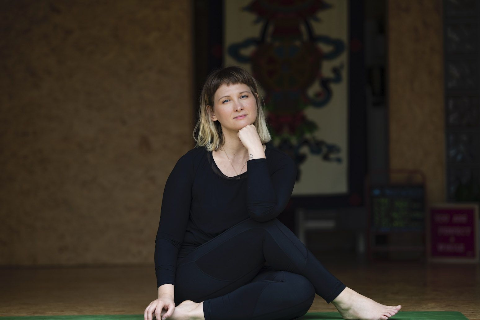 Such a beautiful girl sitting in yoga pose on the mat