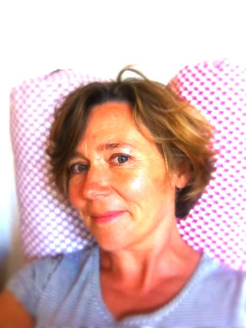 Short haired therapy instructor kept her head on the white pillow