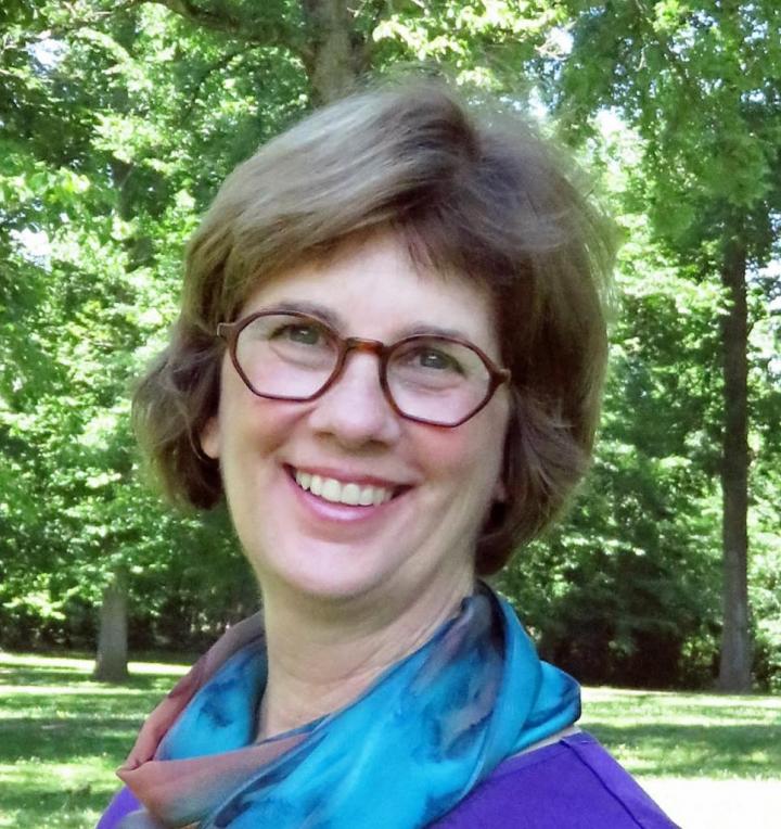 A glasses woman standing in the garden and want to start the exercise