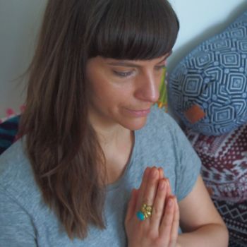 She is sitting on his bed with Molly Maccann's yoga pose and Namaste Symbol