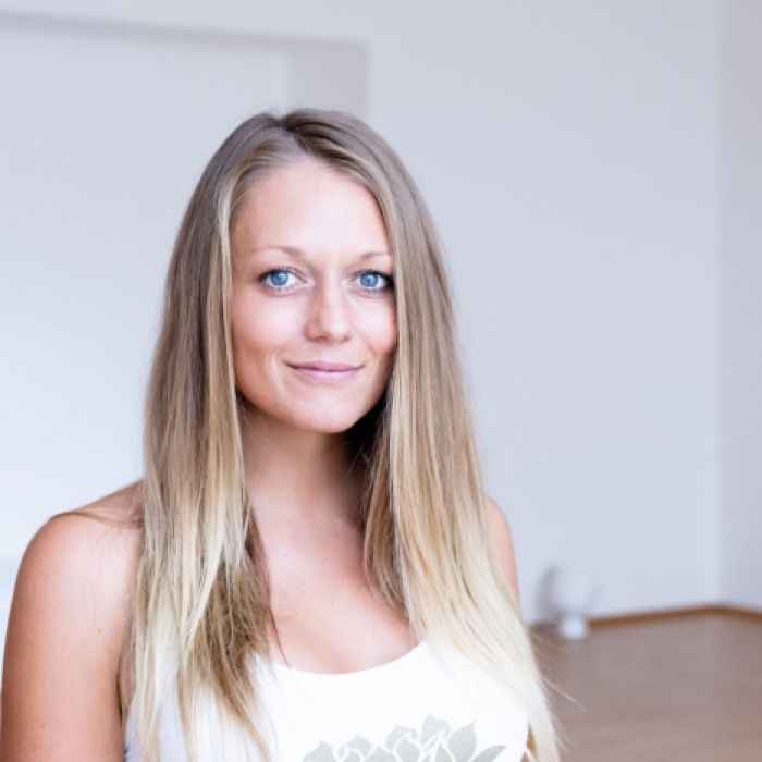 35-year-old woman Looking with regretful eyes at yoga-doing folks