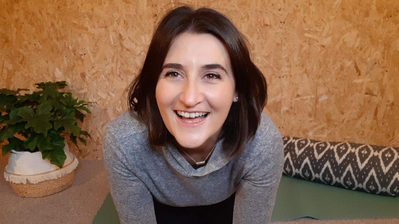 A Woman practicing yoga, with their face turned upward